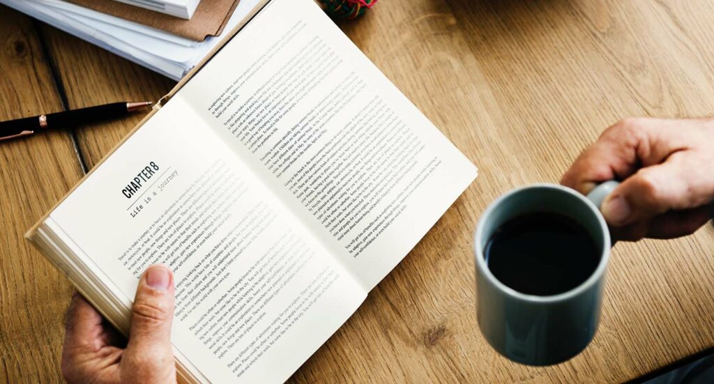 reading a book and drinking coffee